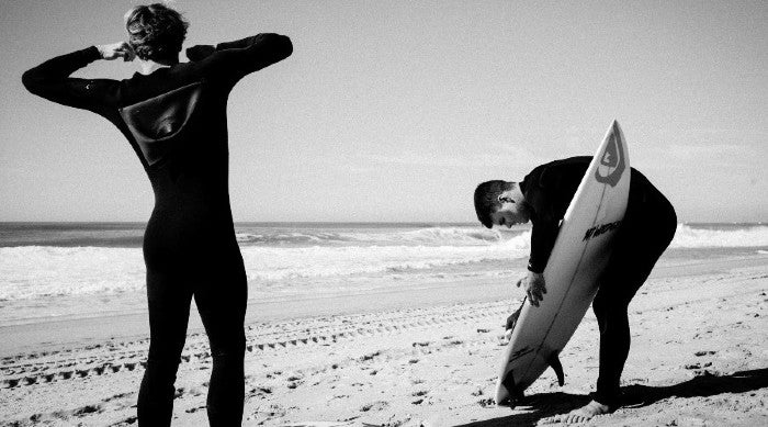 surfers putting on their wetsuit